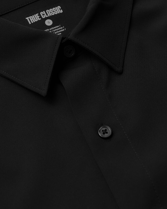Close-up of All Black Short Sleeve Performance Dress Shirt collar and buttons.