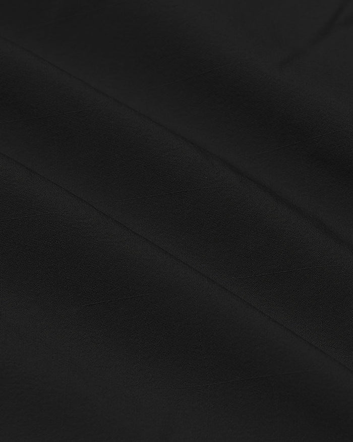 Black Lightweight Dress Shirt with subtle woven texture and diagonal folds.