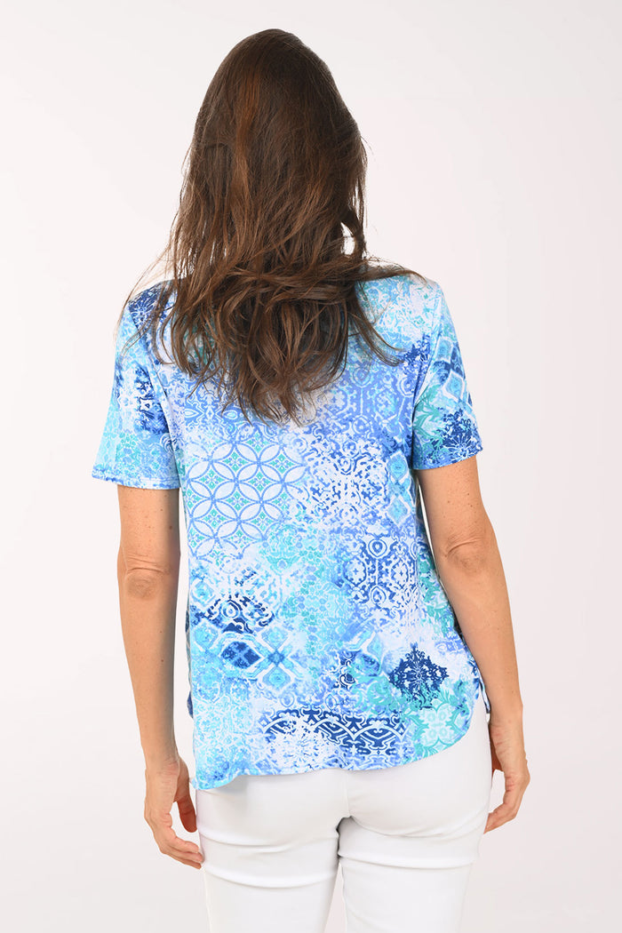 Woman wearing a short sleeve blue top.