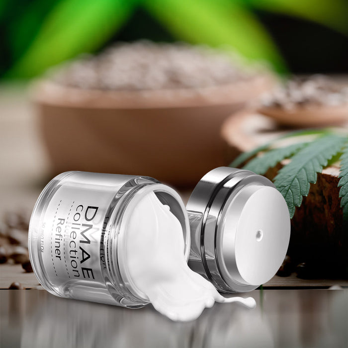 Open jar of DMAE Refiner | SR Cosmetics cream with white lotion spilling out, surrounded by natural ingredients and green leaf in the background, skincare product display.