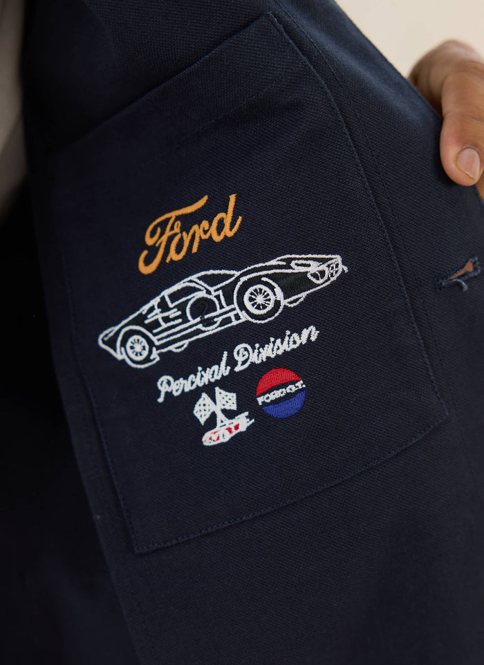 Motorsport-inspired embroidery on the navy cotton canvas pocket of the limited edition Ford x Percival GT40 jacket.