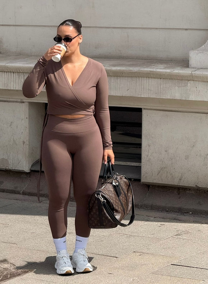 Brown aim'n Shape Seamless Wrap Long Sleeve and matching leggings, providing a smooth second skin feel.