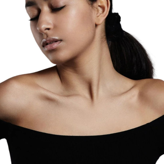 indian woman bare shoulders black dress.best neck skincare kit dermal essentials medical grade skincare