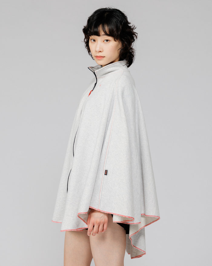 Cropped side view of the Outnback Recovery Cape in marl grey showing the arrow logo tab