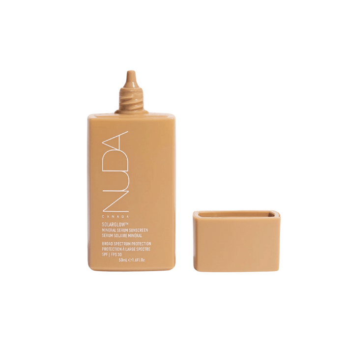 Solarglow™ Mineral Serum Sunscreen | NUDA in a beige rectangular bottle with the cap removed, showcasing its compact skincare packaging for broad spectrum SPF 30 protection.