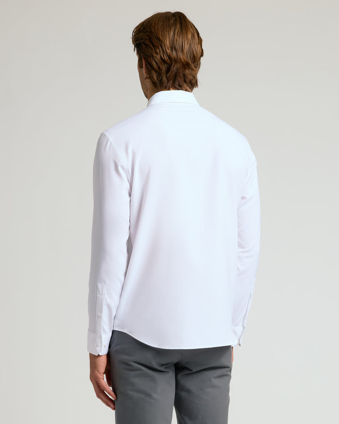 Back view of man in All White Long Sleeve Performance Dress Shirt.