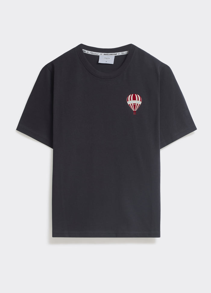 The Percival Balloon T-Shirt in washed black jersey, featuring a red and white striped hot air balloon chest graphic.