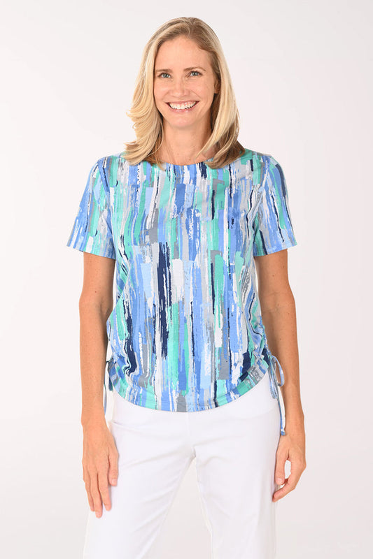 Woman wearing a short sleeve blue top.