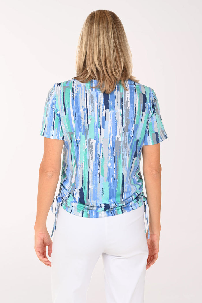 Woman wearing a short sleeve blue top.