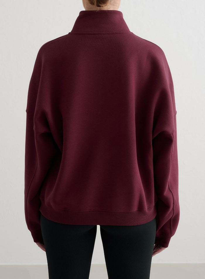 Cherry red aim'n Varsity Sweat Half Zip jumper from the back, featuring a relaxed fit and dropped shoulders.