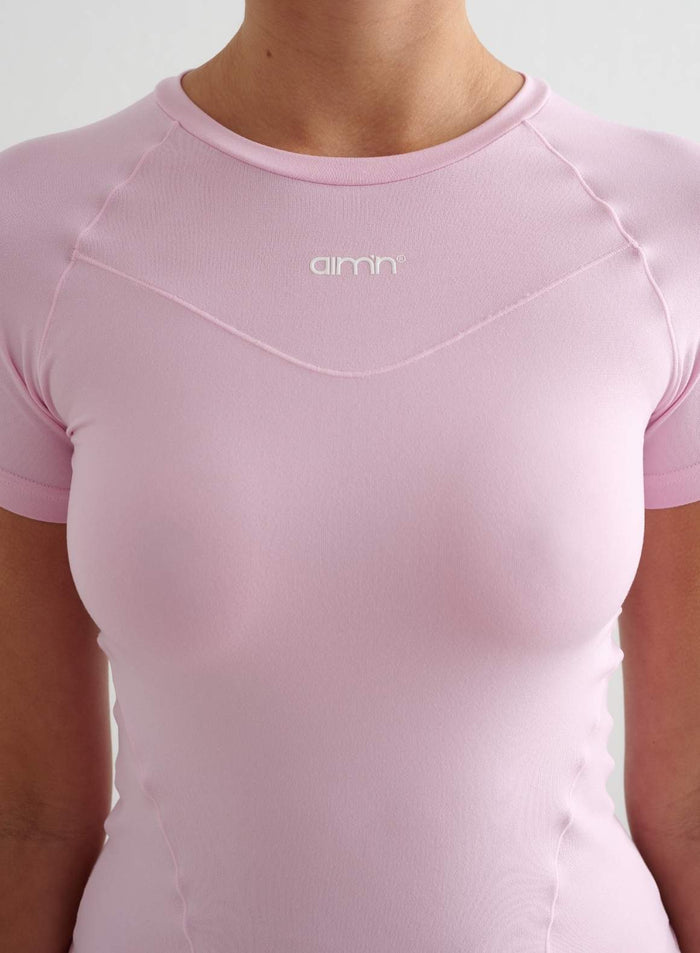 Cotton candy pink Soft Basic Short Sleeve top with a round neck and printed aim'n logo.