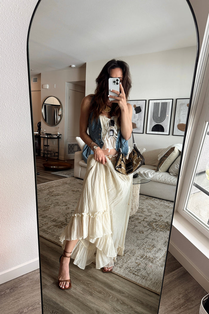Full-length view of the yellow maxi skirt showing the drape and movement.