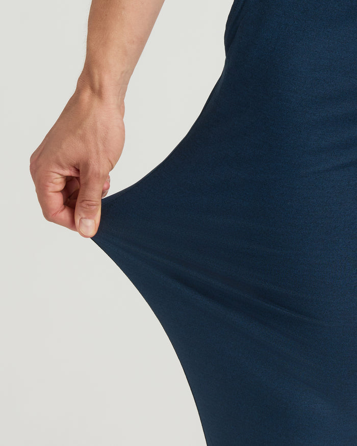 Hand stretching Dark Heather Navy Tall Active Joggers fabric, highlighting elasticity.