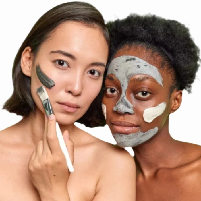 asian woman black woman applying sulphur  acne  facial mask with white brush dermal essentials clinical skincare