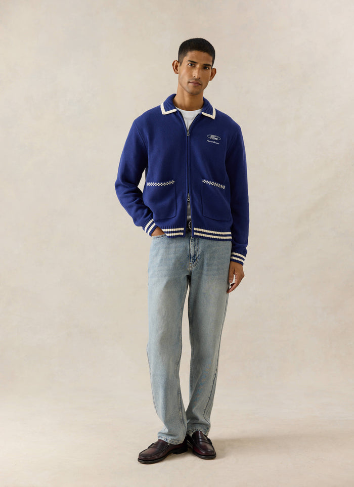 Cobalt blue Percival x Ford Gardner Knitted Zip Cardigan featuring white tipping, styled with light wash denim and loafers.