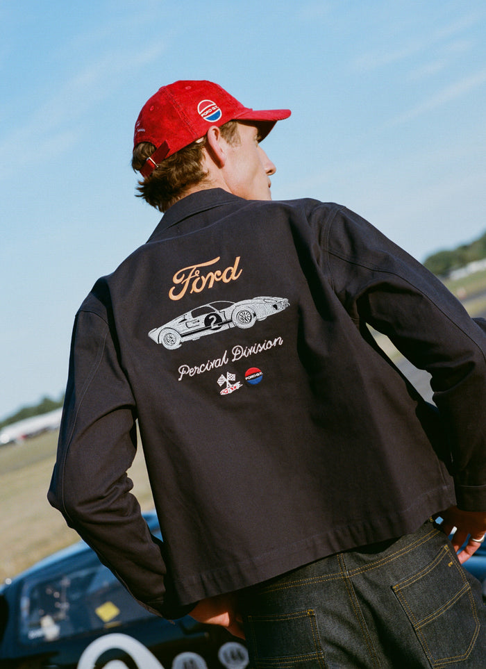 Navy Ford x Percival GT40 embroidered canvas jacket with back graphic, styled with Percival heritage denim jeans.