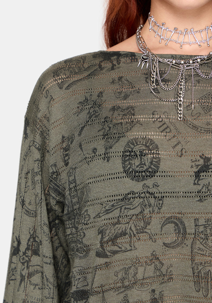 Woman wearing a dark green shirt with zodiac symbol pattern and silver chain necklace.