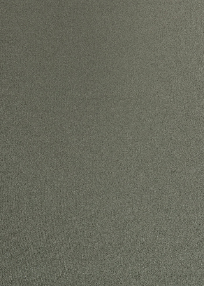 Fabric close-up showing sage green stretch material texture
