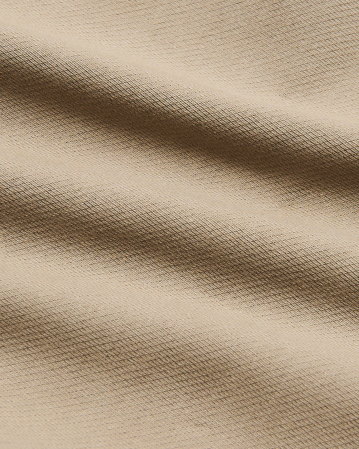Khaki Slim Chino Pants 2.0, ultra-soft beige woven fabric close-up.