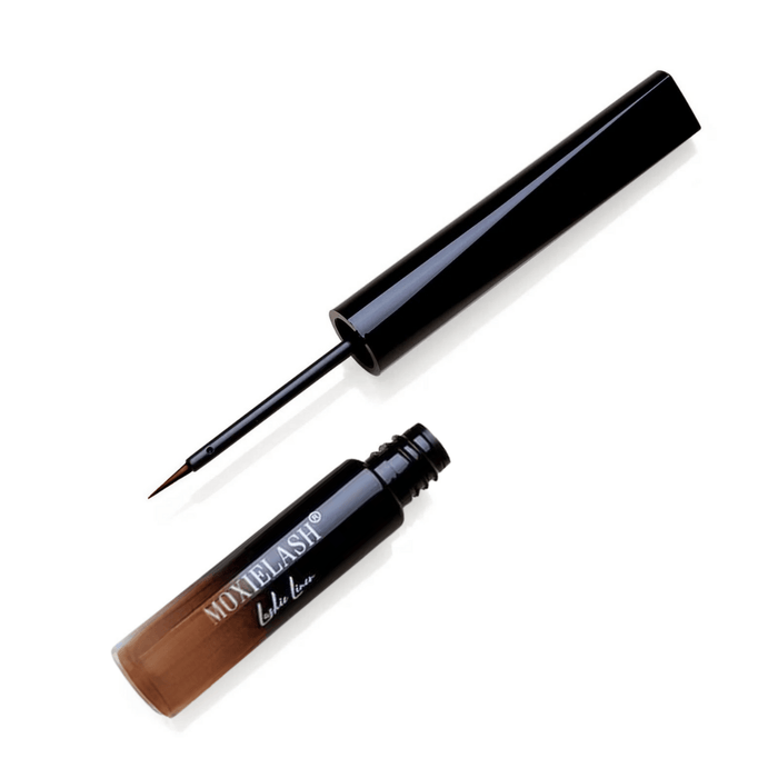 Open black liquid eyeliner with a fine brush applicator, labeled MOXIELASH, designed for precise application and included in Lashies™ - Liner | Moxielash product line.