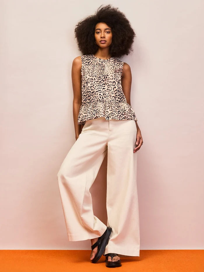 Animal print cotton peplum top with cinched waist seam and flowy silhouette