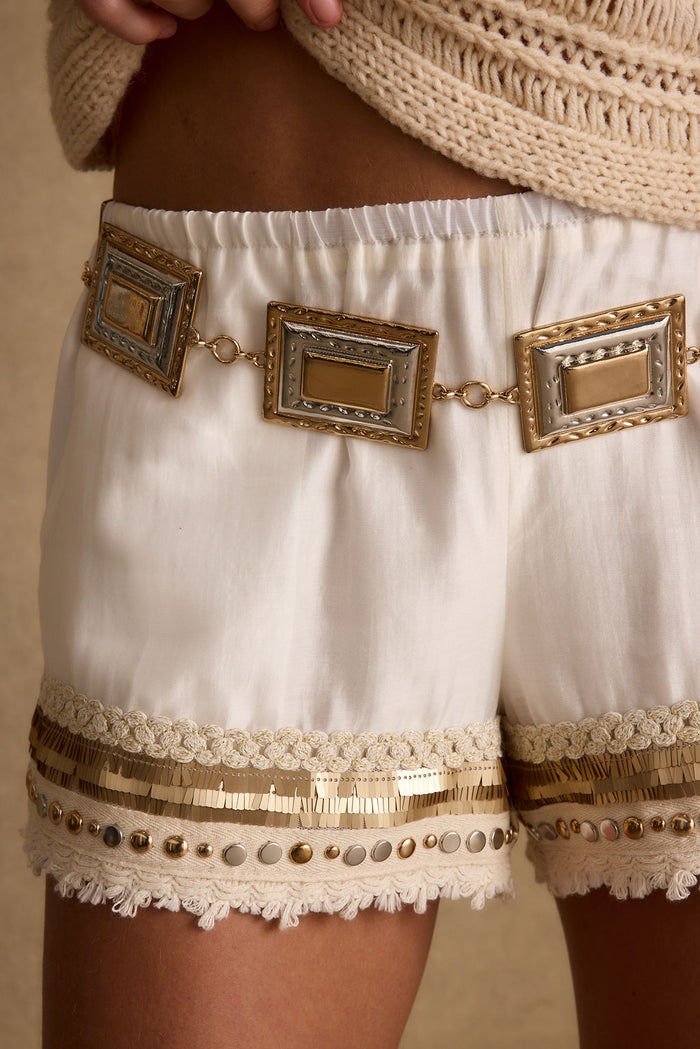 Gold belt with refined detailing and a flattering silhouette.