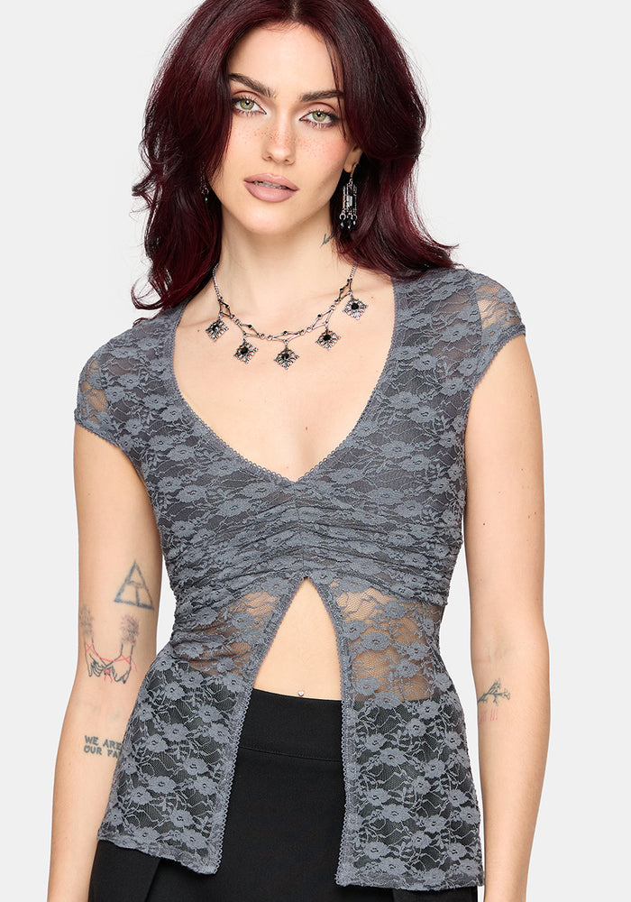Woman wearing a gray lace top with a white background
