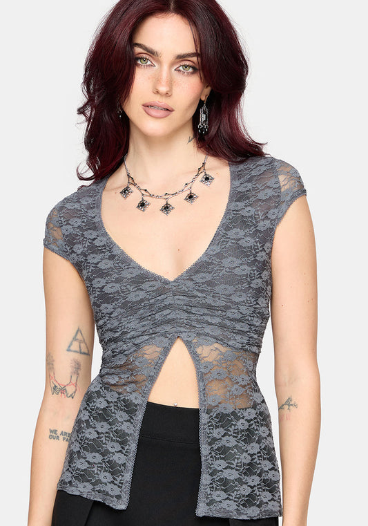 Woman wearing a gray lace top with a white background