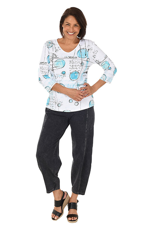 A full length shot of a model wearing a black mineral wash pull-on ankle pants with an elasticized waistband, dual side pockets, and tapered leg design.