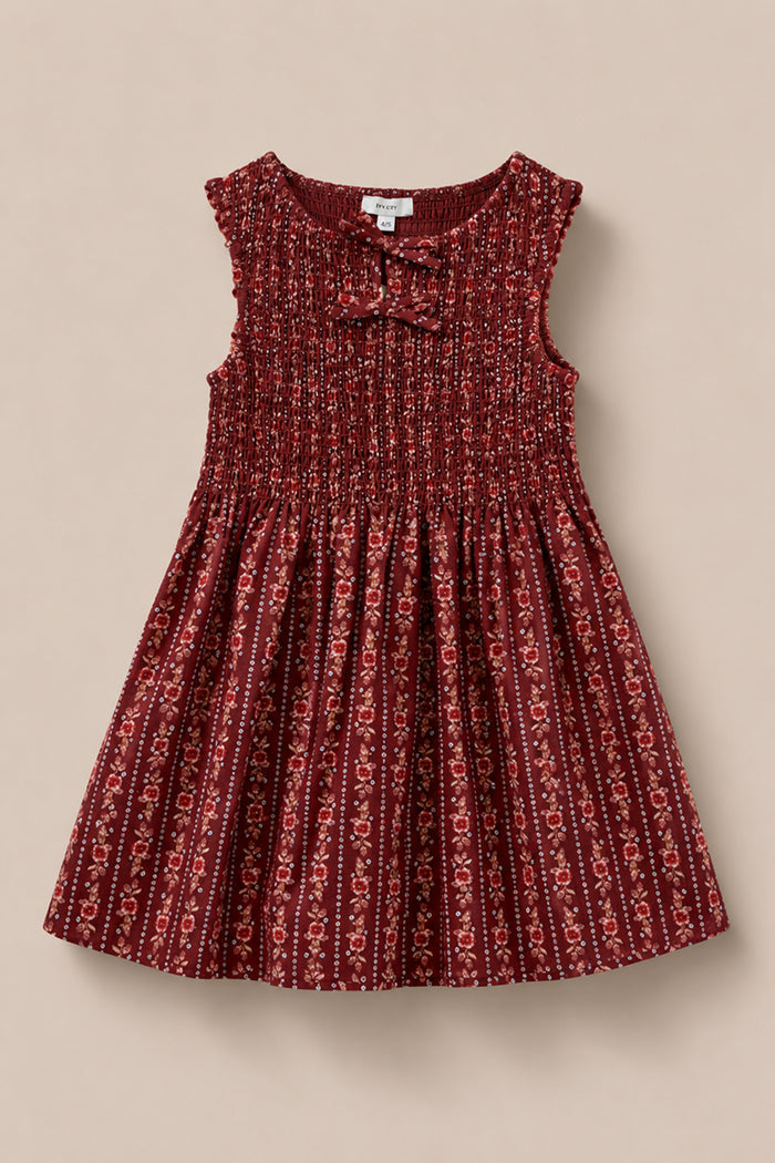 The Mini Ana Dress in Sequoia Felicity Floral by Ivy City Co features a sleeveless design, gathered bodice, and bow neckline, shown against a neutral beige background.
