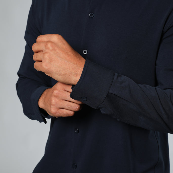 Adjusting cuff of Navy Long Sleeve Knit Shirt.