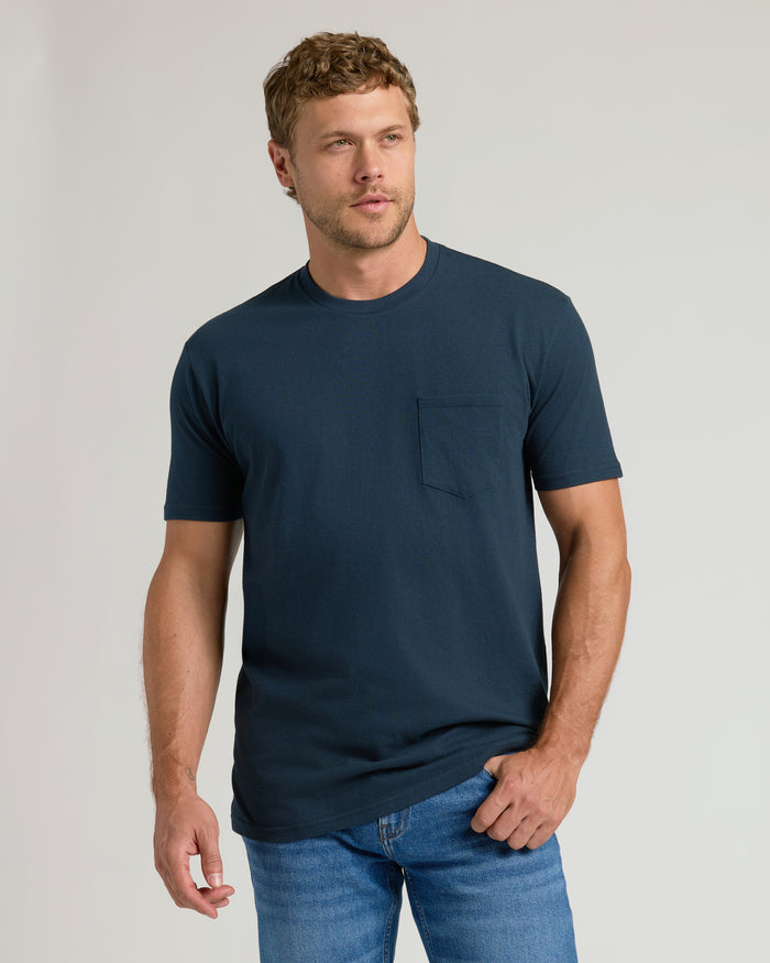 Man wearing Navy Pocket Crew Tee with blue jeans.