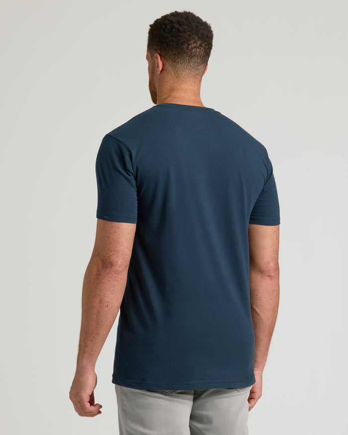 Navy Tall Short Sleeve V-Neck, back view with light gray pants.