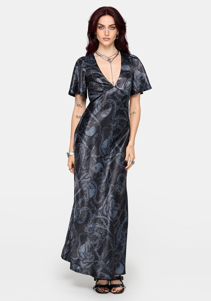 Woman wearing a black maxi satin snake printed dress on a white background