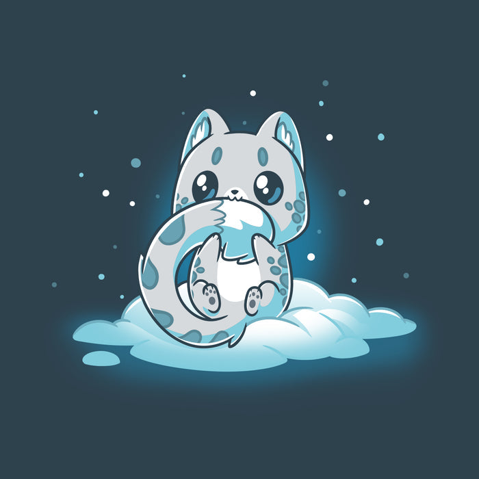 Premium Cotton T-shirt_TeeTurtle denim blue Snuggly Snow Leopard apparel featuring a baby snow leopard with large eyes chewing on its tail. It's sitting in the snow with snowflakes falling around it.