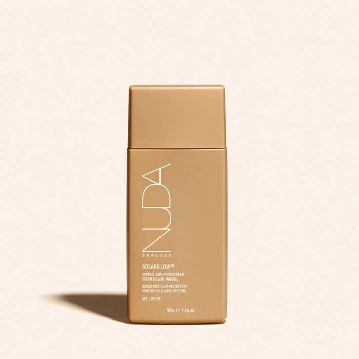 Solarglow™ Mineral Serum Sunscreen | NUDA in a sleek, minimal beige bottle designed for skincare and sun protection with broad spectrum SPF 49.