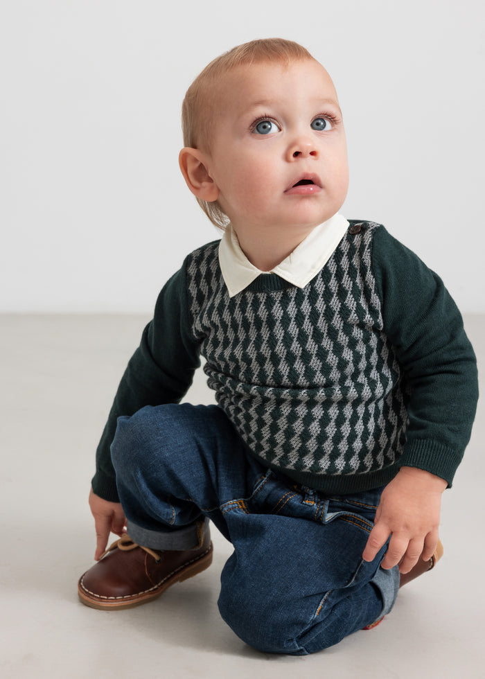 Baby wearing dark green checkered knit blouse with shirt collar and jeans